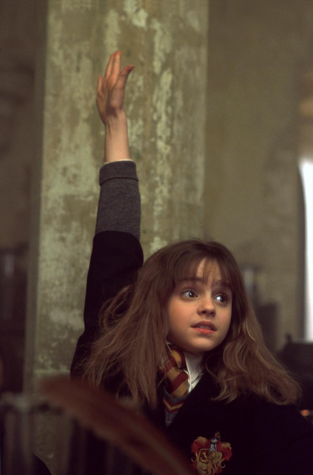 Hermione raising her hand to answer